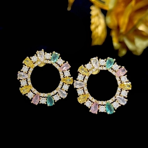 Elegant gold earrings with colorful zircon stones in a circular wreath design