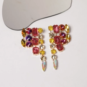 Macro shot of colorful rhinestone teardrop tassel earrings with multi-color crystal gems