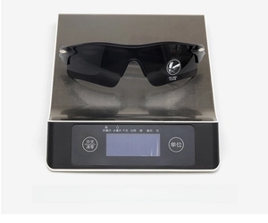 Close-up of lightweight sports cycling sunglasses weighing only 28 grams on a scale