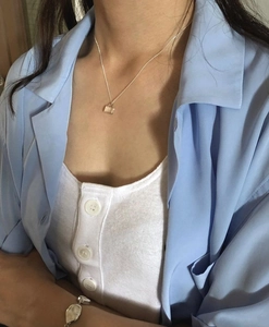 Detail of 925 sterling silver necklace with black zircon lock pendant on model