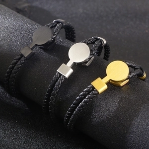 Close-up of braided leather bracelets with metal studs in black, silver and gold