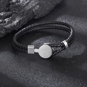 Detail of double-layer braided black leather bracelet with silver metal magnetic clasp