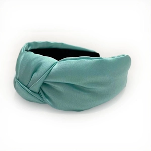 Detailed view of turquoise satin headband featuring premium silk texture and center knot