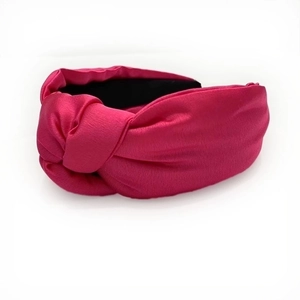 Magenta knotted satin headband with a wide brim and smooth retro glossy finish