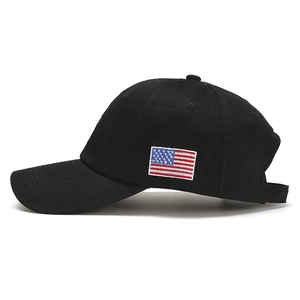 Detailed side view of black baseball cap with embroidered American flag patch