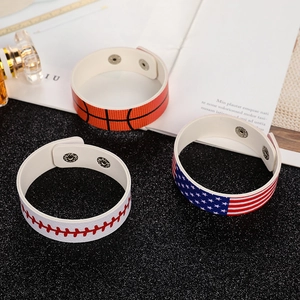 Detail of leather bracelets with basketball, baseball, and USA flag textures and metal snaps