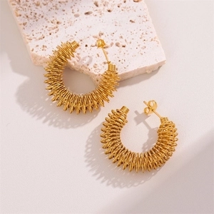 Elegant 18K gold-plated stainless steel twisted C-shape hoop earrings on stone