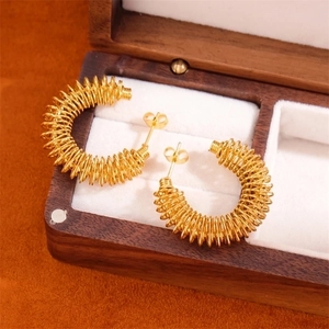 18K gold plated stainless steel twisted C-shape hoop earrings in a wooden jewelry box