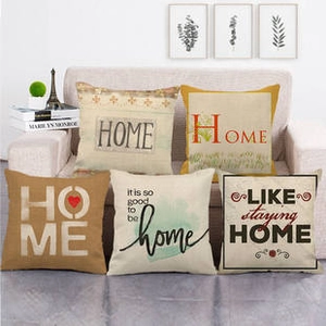 Linen pillowcase collection featuring music and letter designs on a cozy beige sofa