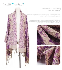 Detail of bohemian jacquard scarf featuring intricate grape flower texture and tassels