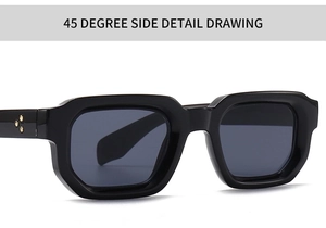 Detail view of black square sunglasses with gold star hardware and grey lenses