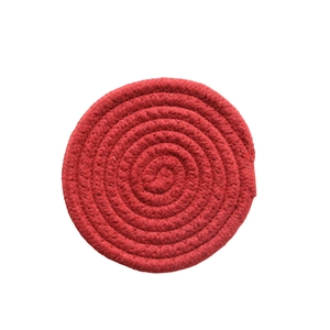 Close-up of spiral woven texture on a round red cotton rope heat-resistant coaster
