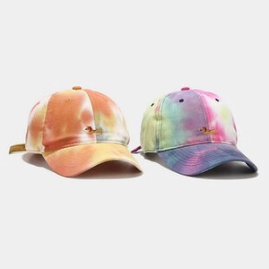 Detailed close-up of macaron tie-dye bucket hats with cute dachshund puppy embroidery