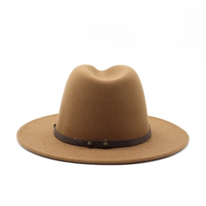 Detail of a brown wool fedora hat featuring a leather band with star metal rivets