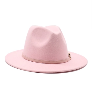 Detailed shot of pink wool fedora hat with wide flat brim and decorative buckle strap