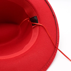 Detailed interior of red fedora hat showing 65% cotton blend fabric and adjustable strap