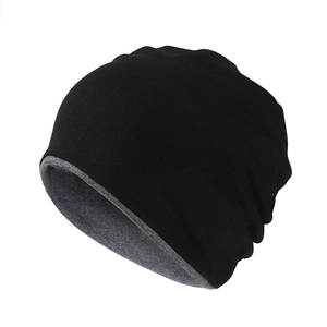 Detail of windproof two-tone knit beanie showing the black exterior and grey lining