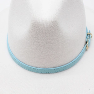 Close-up of a white wool jazz hat with a light blue leather band and golden buckle