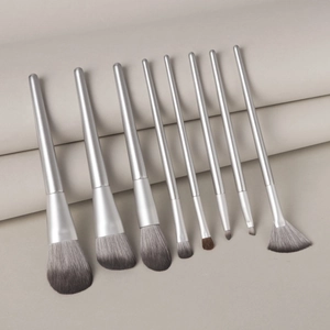 Detail of 9-piece silver metal makeup brush set with grey gradient soft bristles