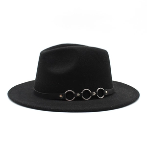 Detail of black wool fedora hat featuring a leather band and silver metal rings
