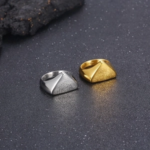 Close-up of geometric stainless steel ring showing dual polished and matte textured finish