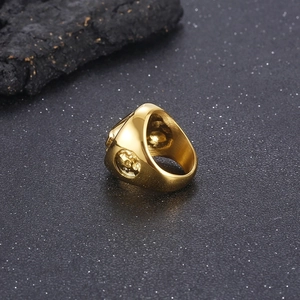 Macro detail of golden punk ring featuring intricate skull relief carving on the side band