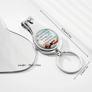 Detail of silver nail clipper keychain with friendship quote under glass dome