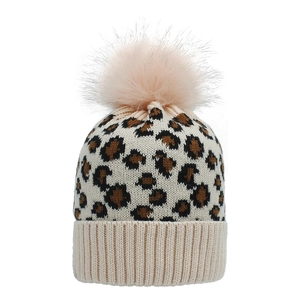 Detail of leopard print knitted beanie with soft faux fur pompom and ribbed cuff