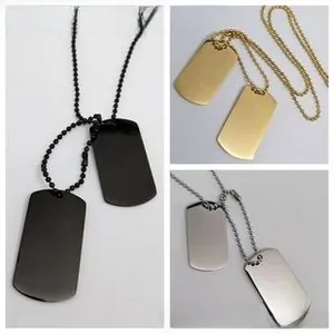 Detailed close-up of dual stainless steel dog tag pendants in black, gold and silver