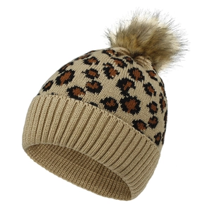 Detail of leopard print knitted beanie with soft faux fur pom-pom and ribbed cuff