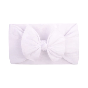 Close-up of a soft white nylon baby headband with a folded bow detail on a plain background