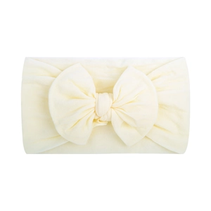 Soft nylon baby headband with a large bow in beige color, perfect for infants