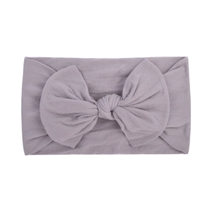 Detail of lavender baby headband featuring a large soft ribbed fabric bow decoration