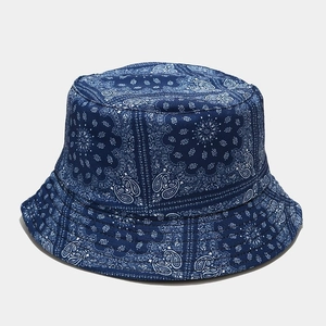 Detailed view of the double-sided blue bucket hat with classic paisley patterns