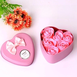 Detail of pink heart-shaped tin box with six soap roses and a sweet love ribbon bow