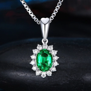 Classic silver necklace featuring an oval green gemstone pendant with zircon halo