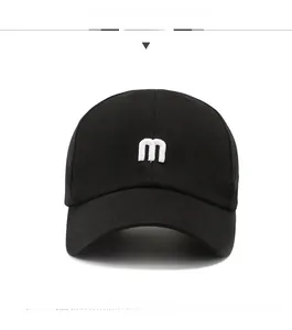 Close-up of black cotton baseball cap featuring high-quality 3D white letter m embroidery