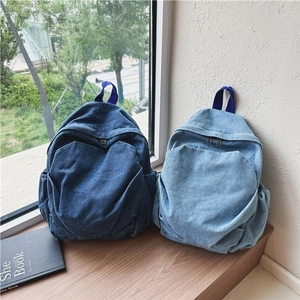 Vintage denim backpacks in dark and light blue for casual travel and daily styling