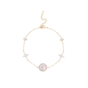 Adjustable gold chain bracelet featuring four-petal flower charms and a round pearl center
