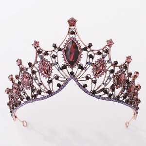 Detailed view of Baroque crown with red crystal and ornate rose gold metal frame