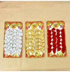 Set of 12 Christmas bow ornaments in red, gold, and silver finishes on linen background