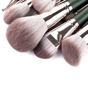 Close-up of soft synthetic bristles and rose gold ferrule details of makeup brushes