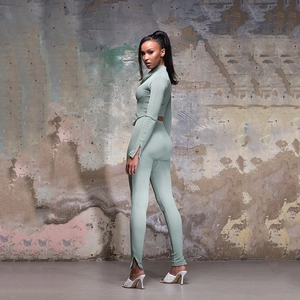 Detail view of light green ribbed fabric set with side slit hem pants and zip-up top
