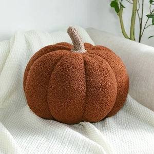 Detailed texture of a soft pumpkin-shaped pillow made from premium orange sherpa fleece