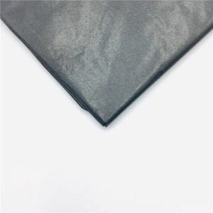 Macro shot of dark grey pearlescent paper with laser sequins and grainy texture