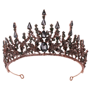 Macro view of baroque bridal tiara with dark grey crystals and antique copper leaf details