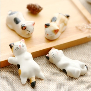 Set of four Japanese style ceramic cat chopstick rests with hand-painted floral patterns