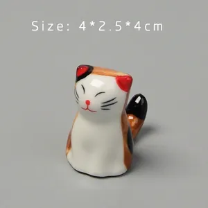 Macro shot of hand-painted ceramic cat chopstick rest with glossy finish and size info