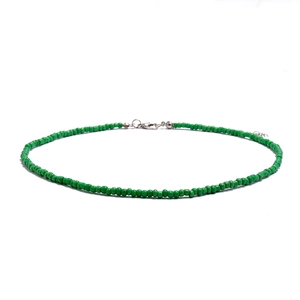 Macro detail of bohemian handmade green seed bead choker with adjustable silver clasp