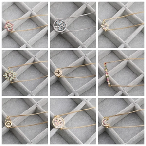 Macro display of nine assorted gold and silver bracelets with colorful zircon charms